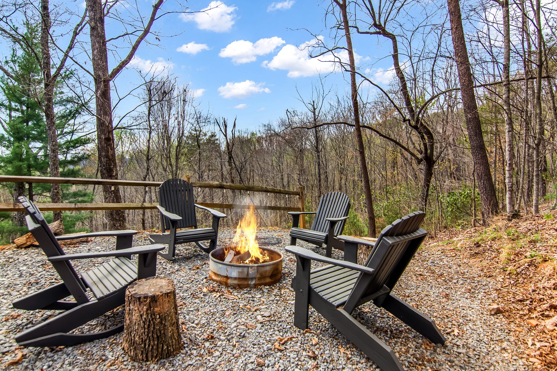 Fire pit area surrounded by Adirondack chairs