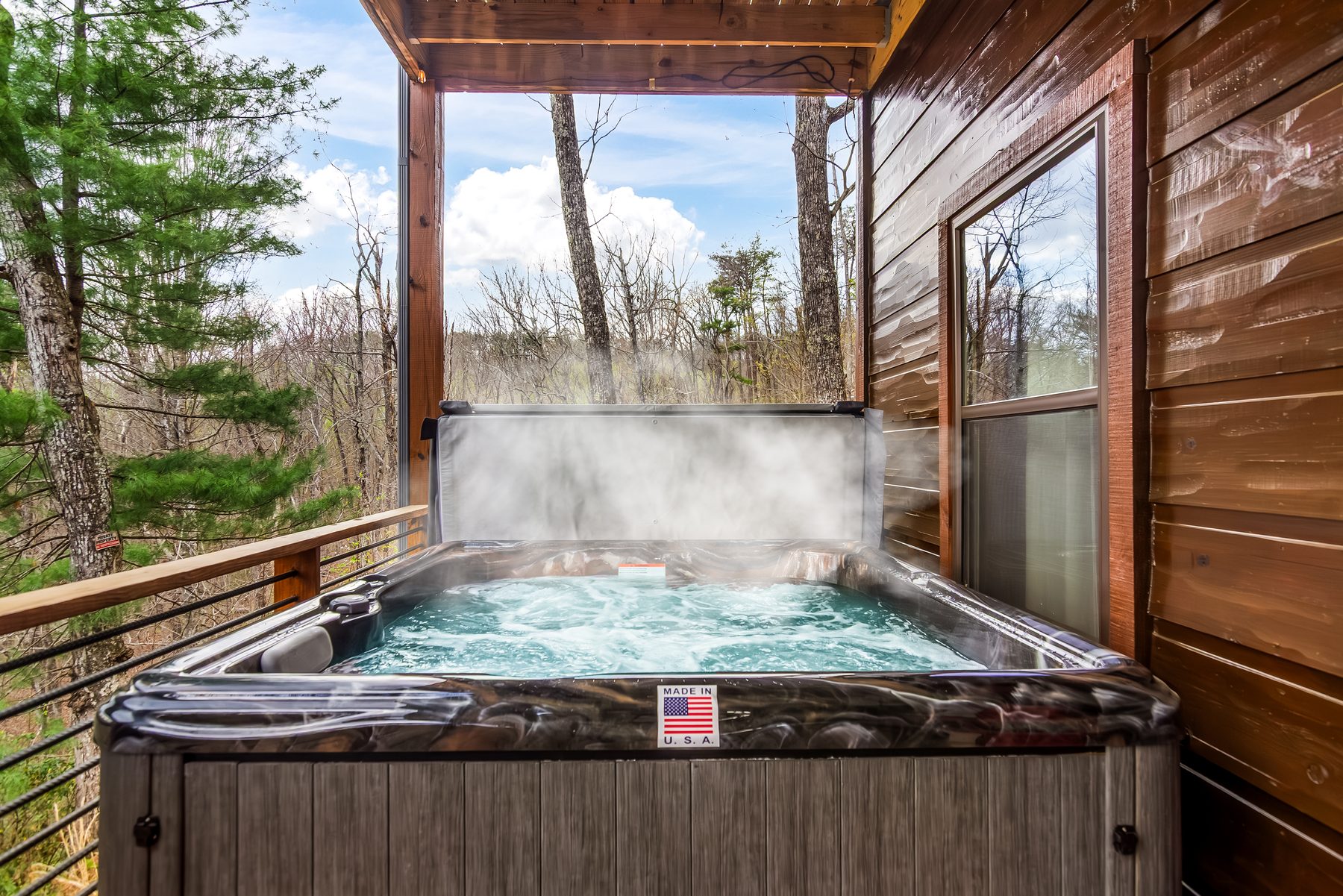 Hot tub bubbling on the covered porch on a sunny afternoon