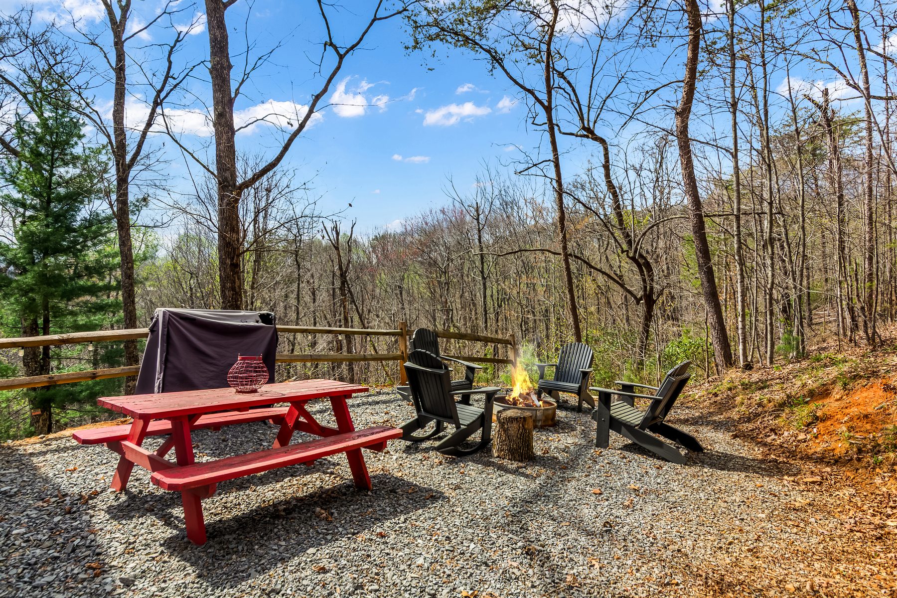 Red picnic table beside the fire pit area